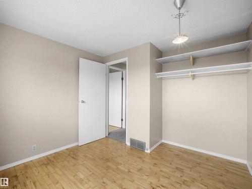 Room featuring wood-finish flooring, neutral wall tones, and white trim - 3509 43A Avenue Nw, Edmonton, AB - Indoor Photo Showing Other Room