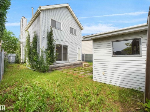 Rear exterior featuring light-colored siding and a multi-level deck - 3509 43A Avenue Nw, Edmonton, AB - Outdoor