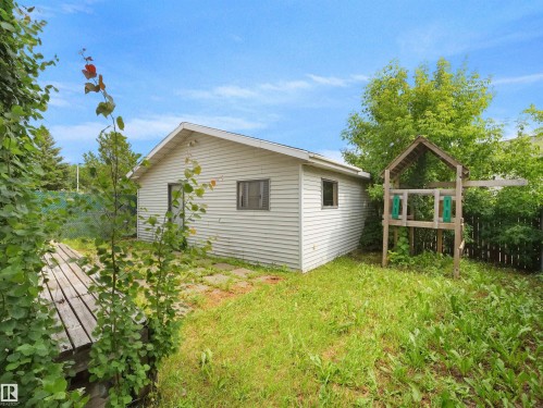 Detached structure featuring horizontal siding, multiple windows, and an exterior door - 3509 43A Avenue Nw, Edmonton, AB - Outdoor