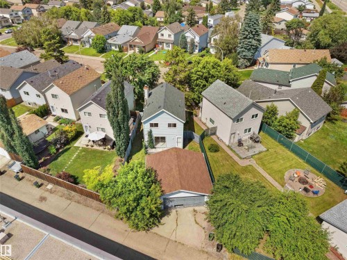 Spacious backyard featuring a manicured lawn, established trees, and a circular patio - 3509 43A Avenue Nw, Edmonton, AB - Outdoor With View