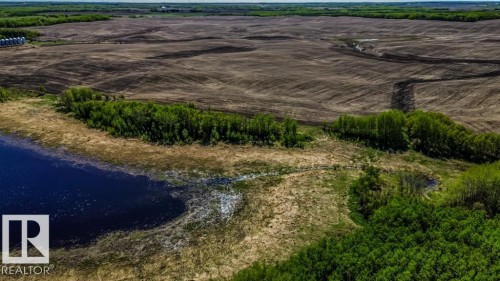 Expansive land featuring a large body of water, dense green foliage, and open tilled fields - 705 59128 Rng Rd 95, Rural St. Paul County, AB 