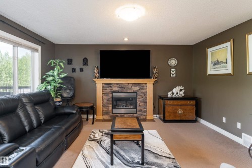 5108 63 Street, Beaumont, AB - Indoor Photo Showing Living Room With Fireplace