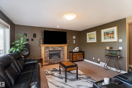 5108 63 Street, Beaumont, AB - Indoor Photo Showing Living Room With Fireplace