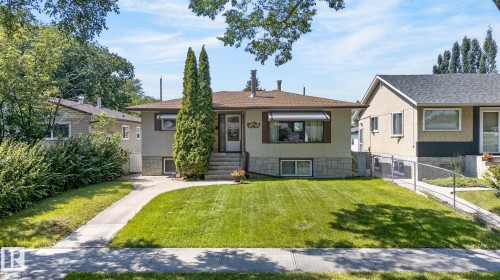 Single-story residence featuring a front yard with mature landscaping, a paved walkway, and concrete steps leading to the main entrance - 12908 104 Street Nw, Edmonton, AB - Outdoor With Facade