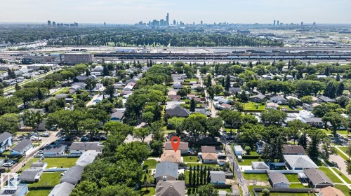 Aerial property overview showcasing a residential neighborhood with a distant cityscape - 12908 104 Street Nw, Edmonton, AB - Outdoor With View