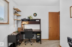 Interior space featuring light-colored walls and carpeted flooring - 