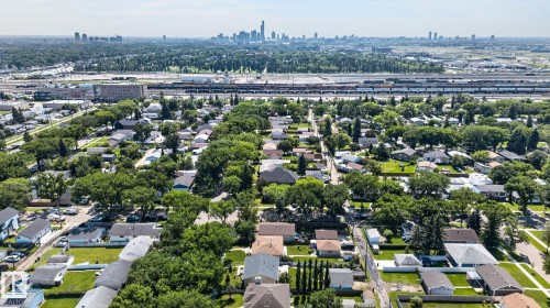 Aerial perspective of a residential neighborhood with a distant cityscape - 12908 104 Street Nw, Edmonton, AB - Outdoor With View