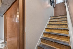 Staircase featuring wood risers and treads, with a white painted handrail - 