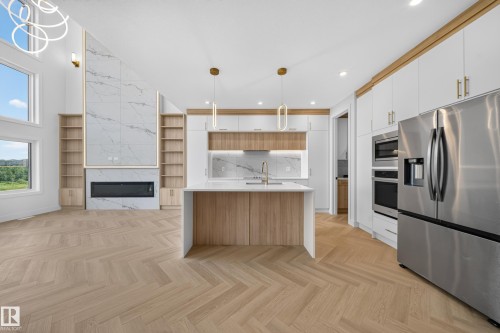 Open-concept living space with herringbone wood-finish flooring - 2808 191 Street Nw, Edmonton, AB - Indoor Photo Showing Kitchen