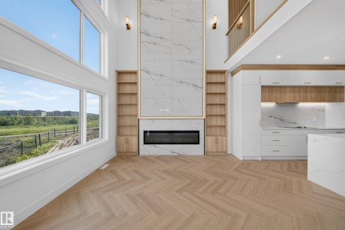Open-concept living space featuring high ceilings and expansive windows - 2808 191 Street Nw, Edmonton, AB - Indoor Photo Showing Kitchen With Fireplace