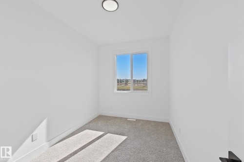 Room featuring light-toned carpeting, white walls, and a recessed ceiling light - 4215 63 Street, Beaumont, AB - Indoor Photo Showing Other Room