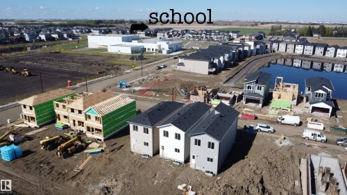 Developing residential neighborhood with a variety of housing styles, including completed units with dark shingle roofs and light-colored siding - 4215 63 Street, Beaumont, AB - Outdoor With View