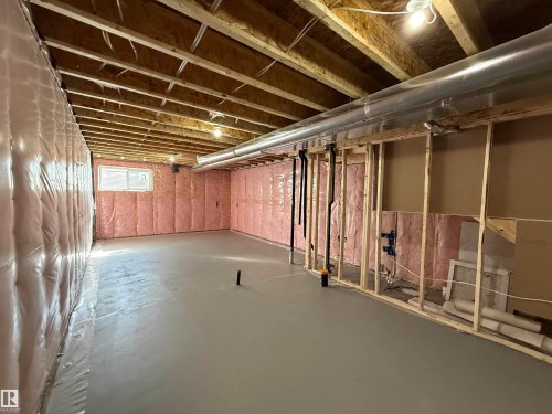 Unfinished basement featuring exposed wood joists, concrete flooring, and insulated walls - 4215 63 Street, Beaumont, AB - Indoor Photo Showing Basement