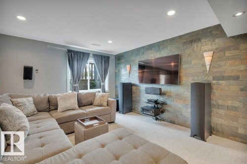Finished basement - family room leading to walkout patio. Beautiful feature wall and plenty of natural light. - #10 15151 43 St Nw, Edmonton, AB - Indoor Photo Showing Living Room With Fireplace
