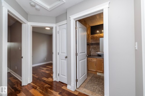 Hallway featuring wood-finish flooring and light gray walls - 11915 77 Street Nw, Edmonton, AB - Indoor Photo Showing Other Room