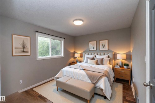 Bedroom featuring wood-finish flooring, a contemporary window with natural light, and neutral wall tones - 11915 77 Street Nw, Edmonton, AB - Indoor Photo Showing Bedroom