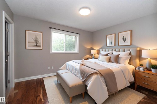 Spacious room featuring wood-finish flooring, a window offering natural light, light gray wall paint, and a neutral-toned ceiling - 11915 77 Street Nw, Edmonton, AB - Indoor Photo Showing Bedroom