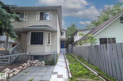 Two-story residence with light-colored siding and a contrasting dark roofline - 11915 77 Street Nw, Edmonton, AB - Outdoor With Exterior