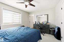 Bright room featuring a window with banded shades, light-colored walls, and a ceiling fan with integrated lighting - 