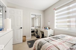 Room featuring a large window with horizontal blinds, neutral wall paint, and carpet flooring - 