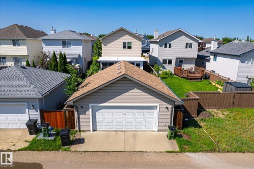 Detached two-car garage with light-colored siding and a brown shingled roof - 4317 152 Avenue Nw, Edmonton, AB - Outdoor