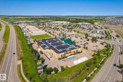 Expansive commercial property featuring a large retail building with multiple loading bays and a prominent multi-tenant sign - 