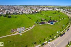 Expansive green space featuring multiple recreational areas, walking paths, and mature trees - 
