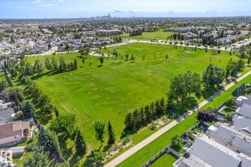 Expansive green space featuring mature trees and a paved pathway - 4317 152 Avenue Nw, Edmonton, AB - Outdoor With View