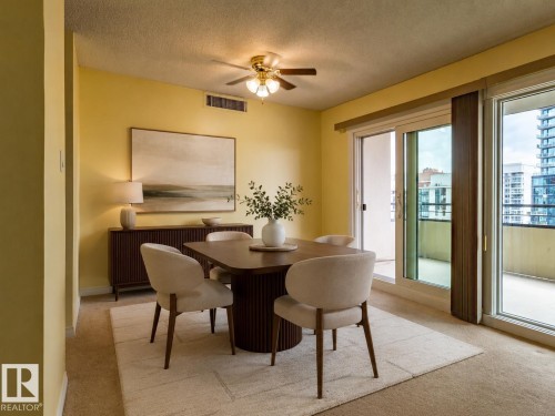 Dining area featuring a ceiling fan, carpet flooring, and a full-height sliding glass door opening to a private balcony - #1210 10140 120 St Nw, Edmonton, AB - Indoor Photo Showing Dining Room