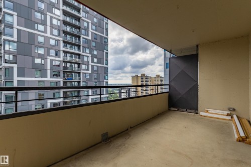 Expansive private balcony with concrete flooring, a black metal railing, and a privacy screen - #1210 10140 120 St Nw, Edmonton, AB - Outdoor With Balcony With Exterior
