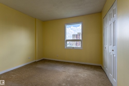 Room featuring light-colored walls and carpeted flooring - #1210 10140 120 St Nw, Edmonton, AB - Indoor Photo Showing Other Room