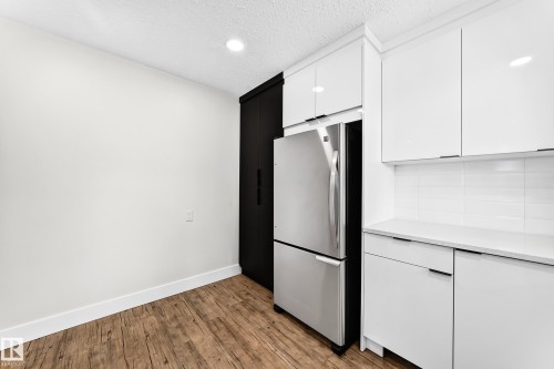 Kitchen featuring wood-finish flooring and recessed lighting - 3119 144 Avenue Nw, Edmonton, AB - Indoor Photo Showing Other Room