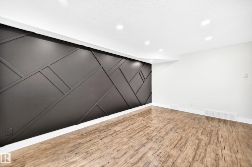 Accent wall featuring geometric paneling and recessed lighting - 3119 144 Avenue Nw, Edmonton, AB - Indoor Photo Showing Other Room