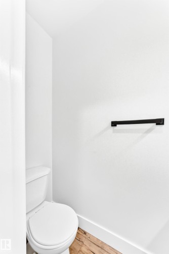 White toilet with a round bowl and tank - 3119 144 Avenue Nw, Edmonton, AB - Indoor Photo Showing Bathroom