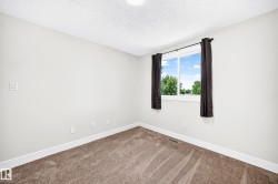 Neutral-toned walls and plush carpeting complement the white trim - 