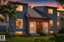 Contemporary multi-level exterior with slate-blue siding and vertical wood-slat accent paneling - 3119 144 Avenue Nw, Edmonton, AB  - Outdoor 