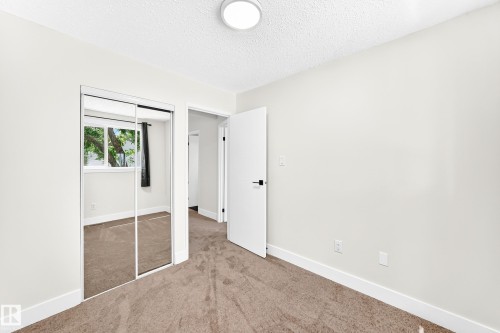 Room featuring neutral-toned carpet, white walls, and a contemporary ceiling light fixture - 3119 144 Avenue Nw, Edmonton, AB - Indoor Photo Showing Other Room