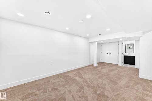Recessed lighting illuminates a spacious room featuring new carpeting and crisp white walls - 3119 144 Avenue Nw, Edmonton, AB - Indoor Photo Showing Other Room