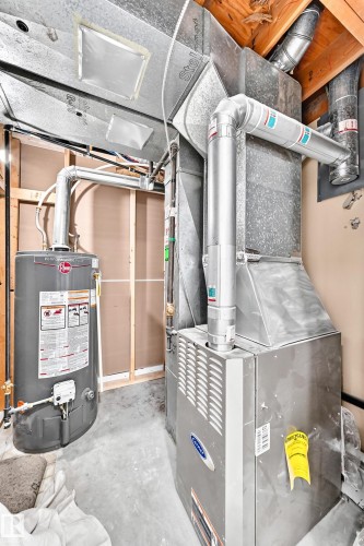 Utility area featuring a water heater, furnace, and extensive ductwork - 3119 144 Avenue Nw, Edmonton, AB - Indoor Photo Showing Basement