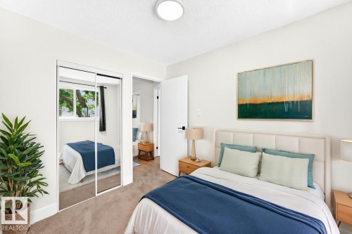 Bedroom featuring plush carpet flooring, a built-in mirrored closet, and a neutral color palette - 3119 144 Avenue Nw, Edmonton, AB - Indoor Photo Showing Bedroom