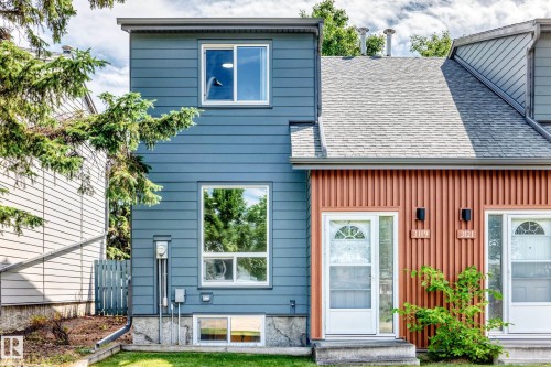 Attached multi-story structure featuring horizontal blue siding and white window frames - 3119 144 Avenue Nw, Edmonton, AB - Outdoor