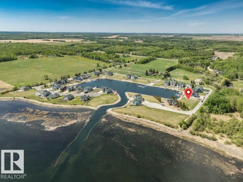 Waterfront property featuring a private boat slip, marina access, and surrounding green spaces - 12 Sunset Harbour, Rural Wetaskiwin County, AB 