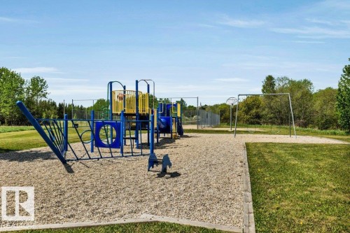 Recreational area featuring a multi-level play structure with slides and climbing elements & a swing set - 12 Sunset Harbour, Rural Wetaskiwin County, AB 