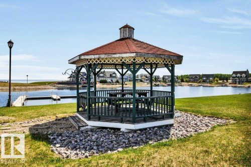 Wood-built gazebo with a red-shingled roof and decorative trim welcomes you! - 12 Sunset Harbour, Rural Wetaskiwin County, AB 