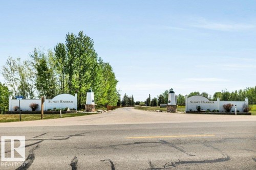 Entrance featuring "Sunset Harbour" Pigeon Lake's ONLY gated community! Cape Cod Architecture - 12 Sunset Harbour, Rural Wetaskiwin County, AB 