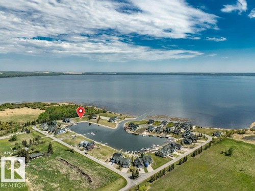 Aerial perspective showcasing Pigeon Lake's only gated community with a private marina - 12 Sunset Harbour, Rural Wetaskiwin County, AB 