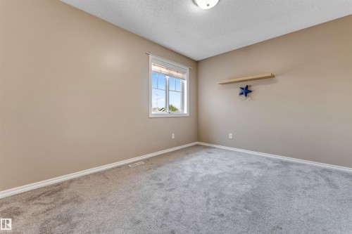 Room featuring neutral wall tones, gray carpeting, and a window with blinds - 121 64 Street Sw, Edmonton, AB - Indoor Photo Showing Other Room