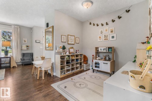 Hardwood-finish flooring extending into an open living area - 4718 35 Avenue Nw, Edmonton, AB - Indoor