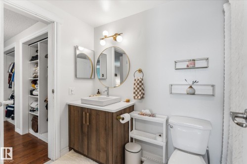 Contemporary bathroom with a wood-finish vanity, square vessel sink, and gold-tone fixtures - 4718 35 Avenue Nw, Edmonton, AB - Indoor Photo Showing Bathroom