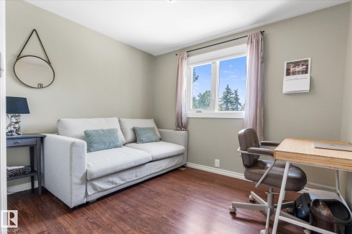 Room featuring wood-finish flooring, a double window, and light gray walls - 4718 35 Avenue Nw, Edmonton, AB - Indoor Photo Showing Office